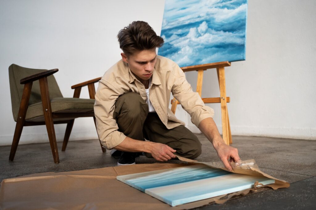 A man wrapping his artwork with packing paper for the house move